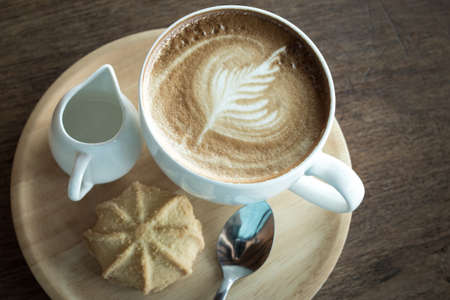 Hot coffee in a white ceramic cup on the top table. Selective focus.の写真素材