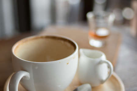 Dirty cup with food scraps on a tableの写真素材