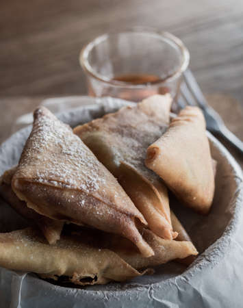 Close up of fried banana with honey syrup on the wooden table. Selective focus