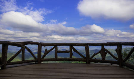 Wooden balcony on the viewpoint. Mountain and forest in the afternoon , Thailand.