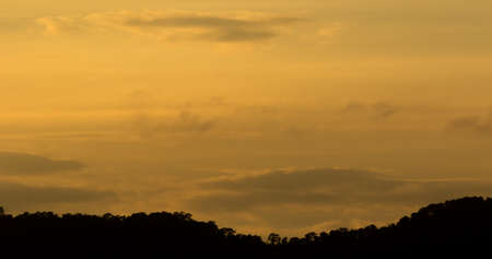 Sunset behind the mountain silhouette.の写真素材