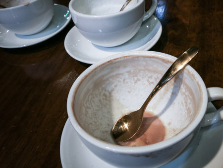 Dirty cup with food scraps on a tableの写真素材