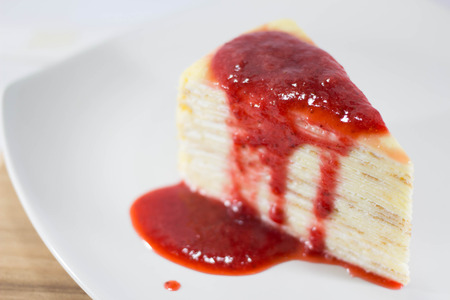 Crepe Cake with strawberry source on dishの写真素材