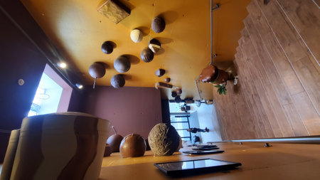Interior of a modern coffee shop with ceramic pots and candles.の写真素材