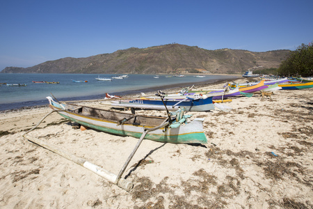 Tropical sandy beach with buildings and boats in a sea. Gili Trawangan, Indonesiaの写真素材