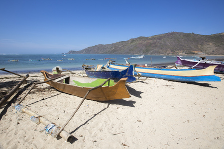 Tropical sandy beach with buildings and boats in a sea. Gili Trawangan, Indonesiaの写真素材