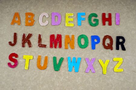 Alphabets isolated on wooden board.