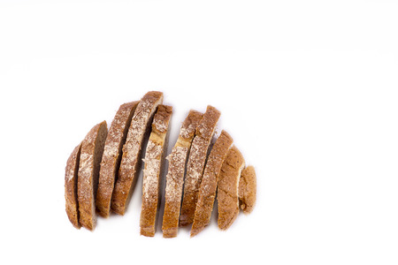 fresh sliced bread and wheat on wooden board isolated on white