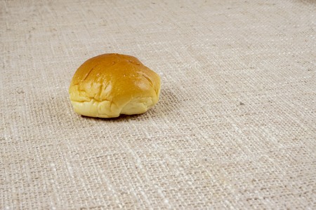 fresh sliced bread and wheat on wooden board isolated on white