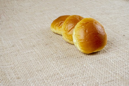 fresh sliced bread and wheat on wooden board isolated on whiteの写真素材