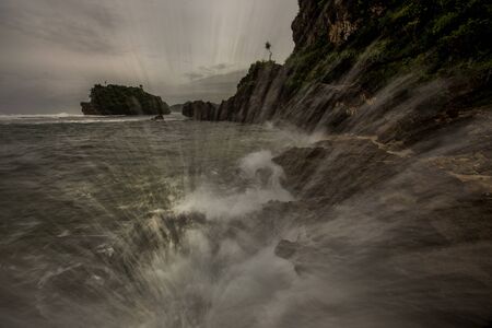 Amazing view of Yogyakarta seascape with natural coastal rock as foreground