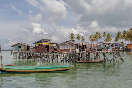 Sabah, Malaysia-July 10, 2016:Daily life of unidentified seagypsy fisherman people in Mabul Island, Malaysia. Seagypsy people is a nomadic and stay in the wooden boat or canoe.のeditorial素材