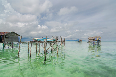 Sabah, Malaysia-July 10, 2016:Daily life of unidentified seagypsy fisherman people in Mabul Island, Malaysia. Seagypsy people is a nomadic and stay in the wooden boat or canoe.のeditorial素材