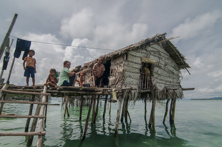 Sabah, Malaysia-July 10, 2016:Daily life of unidentified seagypsy fisherman people in Mabul Island, Malaysia. Seagypsy people is a nomadic and stay in the wooden boat or canoe.のeditorial素材