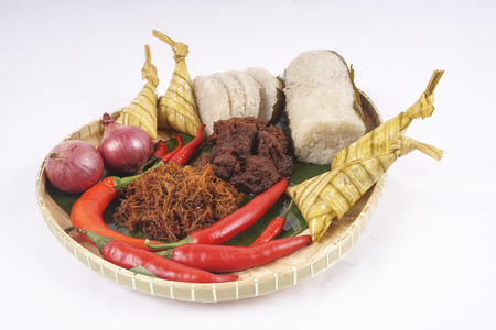 Famous traditional Malay foods during Ramadhan, Eid Fitr and Eid Adha i.e. of lemang (bamboo rice) ,ketupat (dumpling rice in coconut leaf) dan rendang beef. DOF and copy space.の写真素材