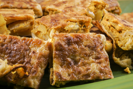 Murtabak or martabak, also mutabbaq, is a stuffed pancake or pan-fried bread which is commonly found in Saudi Arabia, Yemen, India, Indonesia, Malaysia, Singapore, Brunei and Thailand.の写真素材