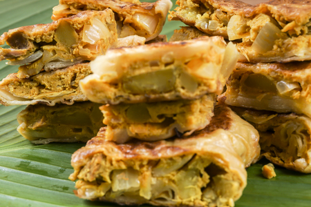 Murtabak or martabak, also mutabbaq, is a stuffed pancake or pan-fried bread which is commonly found in Saudi Arabia, Yemen, India, Indonesia, Malaysia, Singapore, Brunei and Thailand.の写真素材