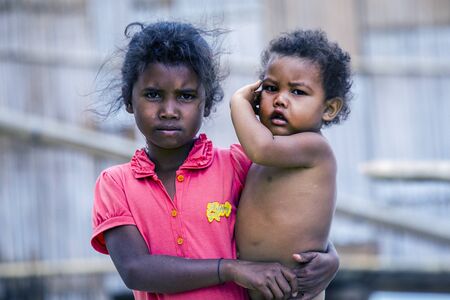 Royal Belum, Malaysia - 2 November 2015 : Indigenous boys seen in front of their traditional hut in Royal Belum rainforest, Gerik, Malaysia on November 2.のeditorial素材