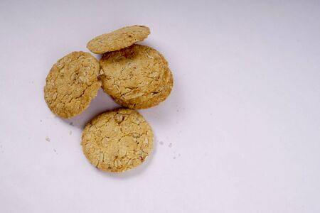 a pile of oats biscuits on a white backgroundの写真素材