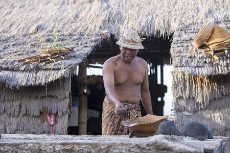 BALI, INDONESIA - May 8,2015 : Unidentified local people work as natural salt farmer at Kasumba Beach, Bali. He collecting sea water and make salt naturally.のeditorial素材