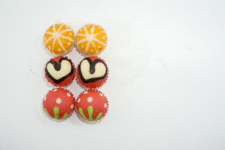 colorful cup cakes on a white backgroundの写真素材