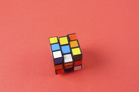 Kuala Lumpur, 24 February 2017.Rubik cube isolated on red background. Problem solving concept.