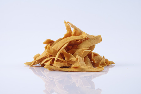 Pile of dry roasted Indian snack mix, isolated over white