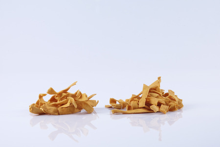 Pile of dry roasted Indian snack mix, isolated over whiteの写真素材