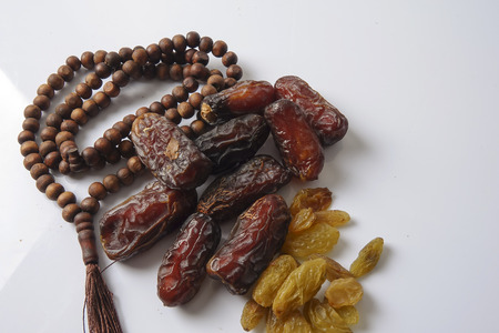 Dates,raisin and rosary isolated on white.の写真素材