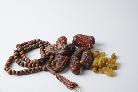 Dates,raisin and rosary isolated on white.の写真素材
