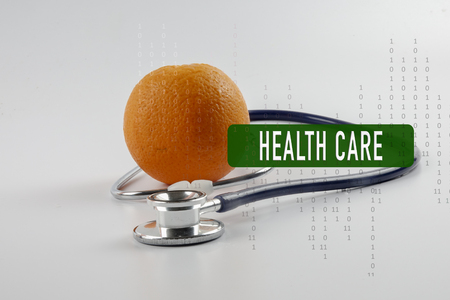 Orange and stethoscope with conceptual text cloud.の写真素材