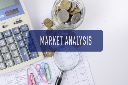 Magnify glass,coins and calculator. Business concept.の写真素材