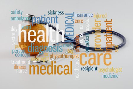 Orange and stethoscope with conceptual text cloud.の写真素材