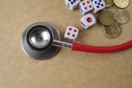 Red stethescope on wooden background. Medical and health care concept.の写真素材