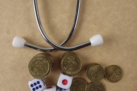 Red stethescope on wooden background. Medical and health care concept.の写真素材