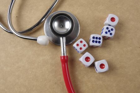 Red stethescope on wooden background. Medical and health care concept.の写真素材