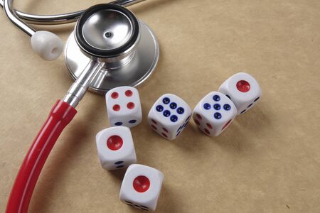 Red stethescope on wooden background. Medical and health care concept.の写真素材