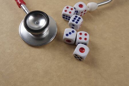 Red stethescope on wooden background. Medical and health care concept.の写真素材