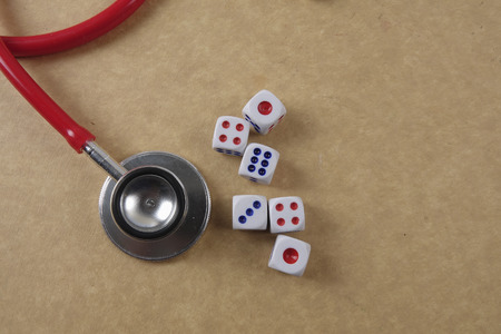 Red stethescope on wooden background. Medical and health care concept.の写真素材