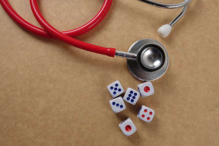 Red stethescope on wooden background. Medical and health care concept.の写真素材