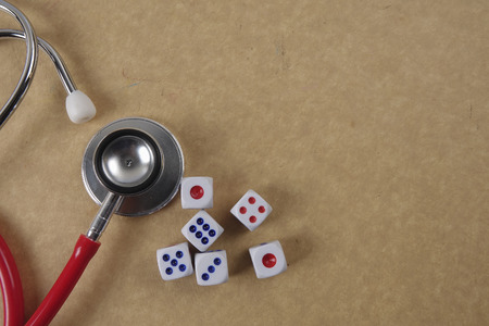 Red stethescope on wooden background. Medical and health care concept.の写真素材