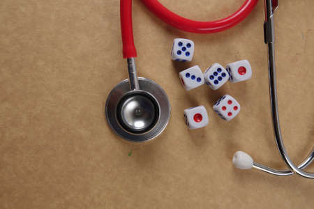 Red stethescope on wooden background. Medical and health care concept.の写真素材