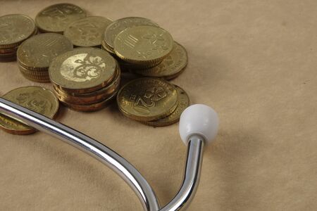 Red stethescope on wooden background. Medical and health care concept.の写真素材