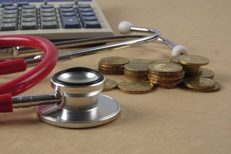 Red stethescope on wooden background. Medical and health care concept.の写真素材
