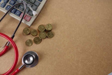 Red stethescope on wooden background. Medical and health care concept.の写真素材