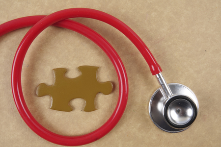 Medical concept with stethoscope,piece of puzzle and coins .の写真素材