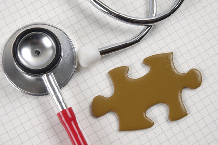 Medical concept with stethoscope,piece of puzzle and coins .の写真素材