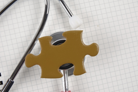 Medical concept with stethoscope,piece of puzzle and coins .の写真素材