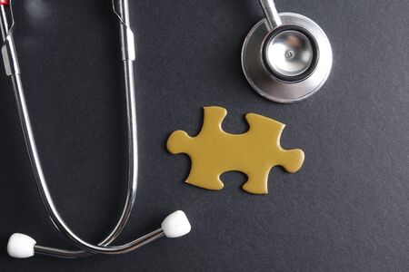 Red stethoscope,keyboard ,puzzle and coins. Medical concept.の写真素材