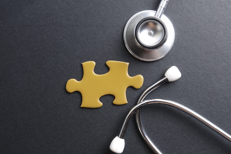 Red stethoscope,keyboard ,puzzle and coins. Medical concept.の写真素材